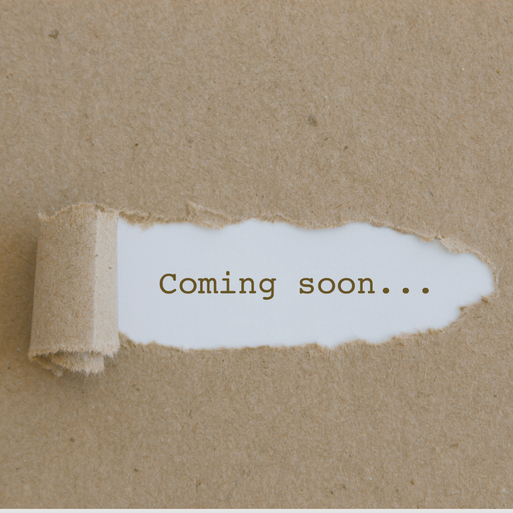 A textured brown paper background with a torn edge revealing the text 'Coming soon...' on a white strip underneath.