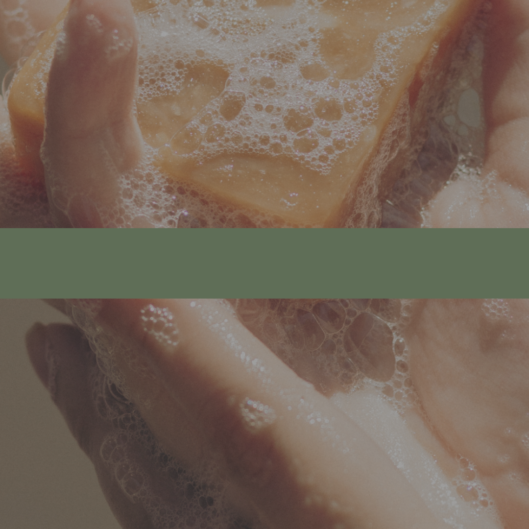 Close-up of hands holding a soap bar with bubbles